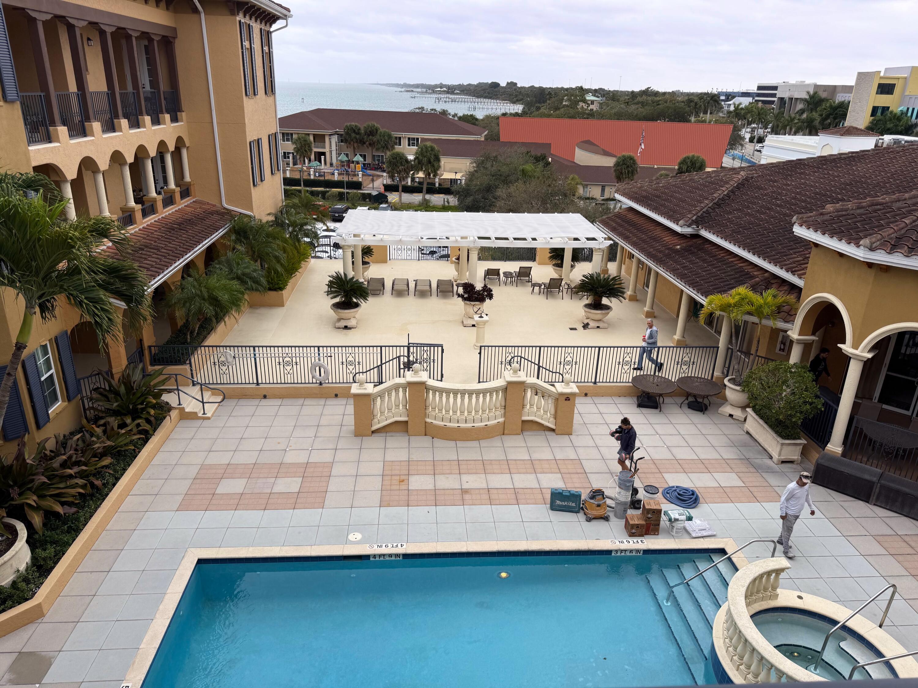 20 Orange Avenue, Unit 9 Fort Pierce, FL 34950 - Photo 18 of 92 a view of a patio with table and chairs with wooden floor and fence