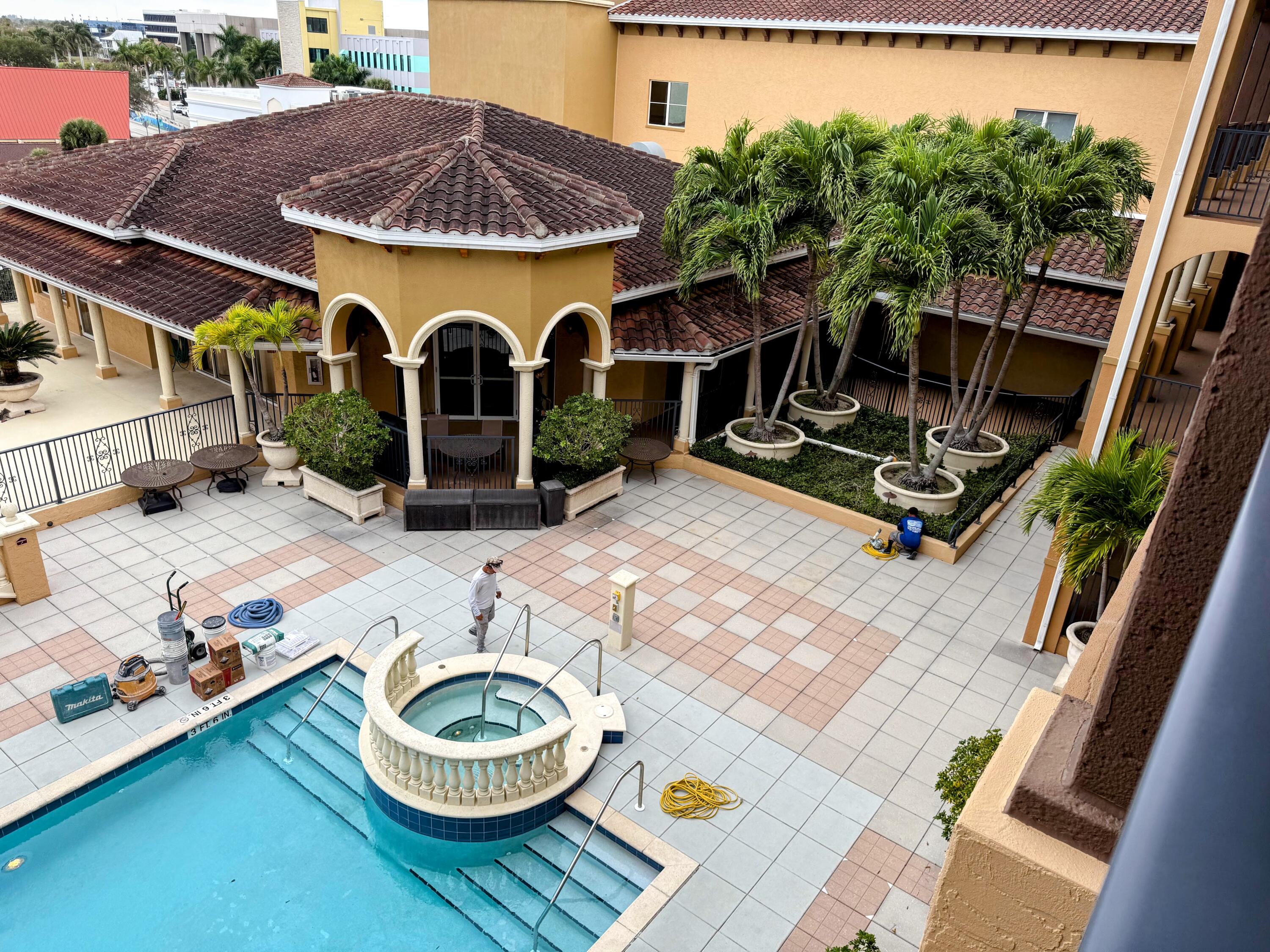 20 Orange Avenue, Unit 9 Fort Pierce, FL 34950 - Photo 20 of 92 a backyard of a house with barbeque oven table and chairs