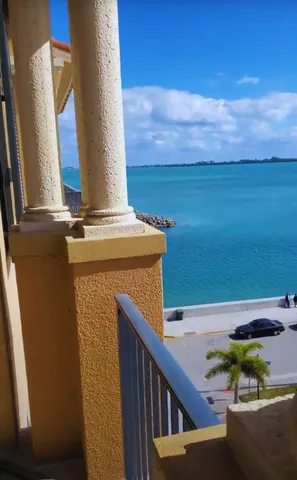 a room with painting on the wall and a potted plant