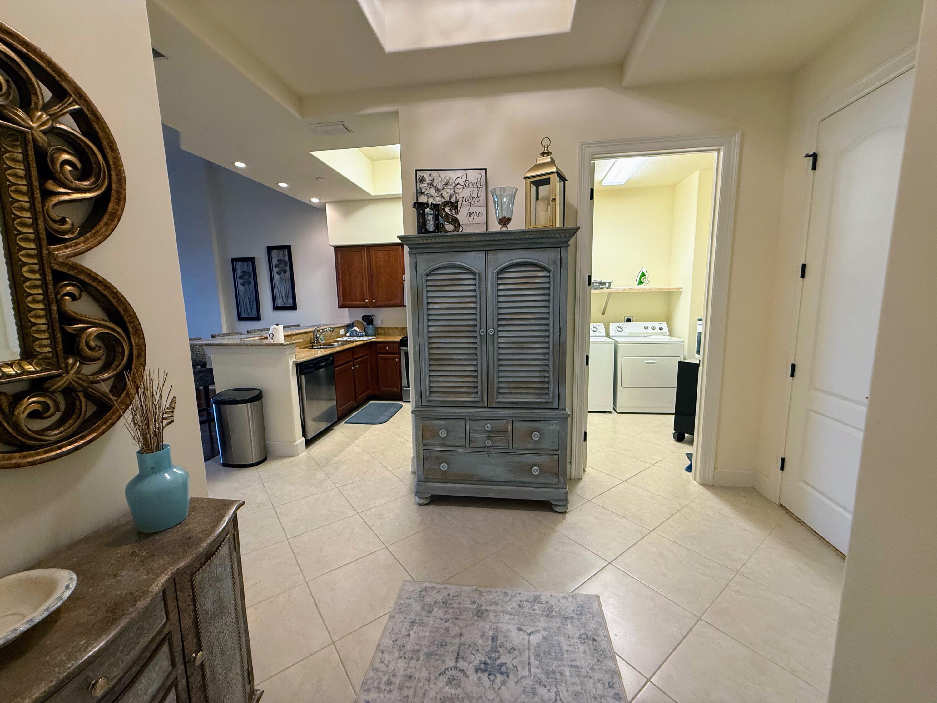20 Orange Avenue, Unit 9 Fort Pierce, FL 34950 - Photo 34 of 92 a kitchen with stainless steel appliances kitchen island granite countertop a stove and a refrigerator