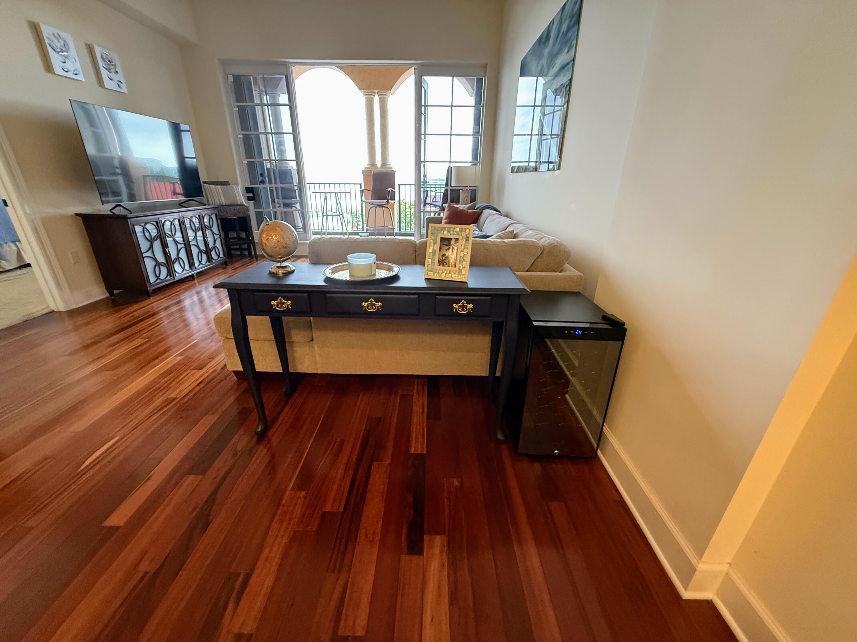 20 Orange Avenue, Unit 9 Fort Pierce, FL 34950 - Photo 60 of 92 a living room with furniture and a wooden floor