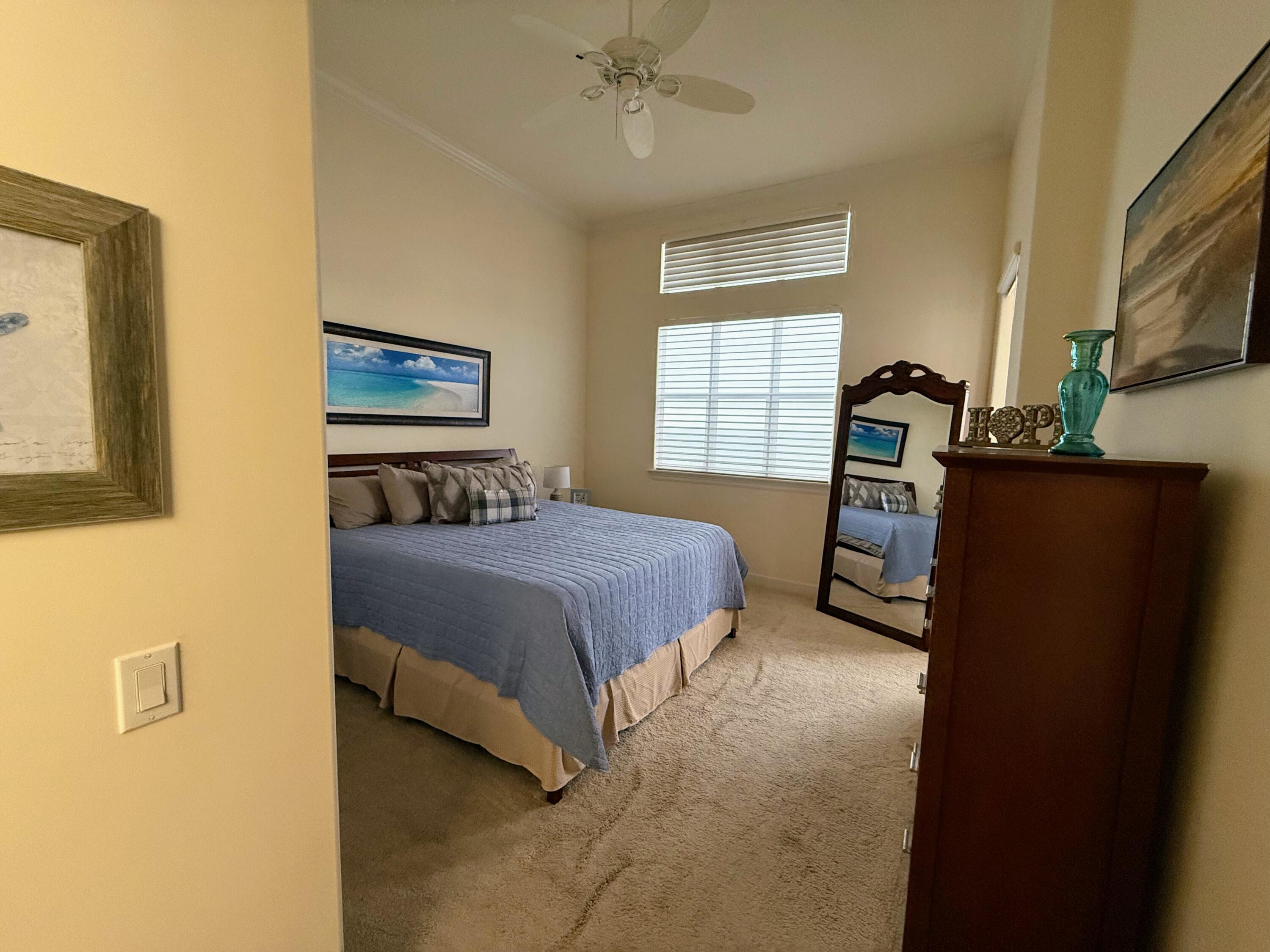 20 Orange Avenue, Unit 9 Fort Pierce, FL 34950 - Photo 66 of 92 a bedroom with a bed dresser and a window