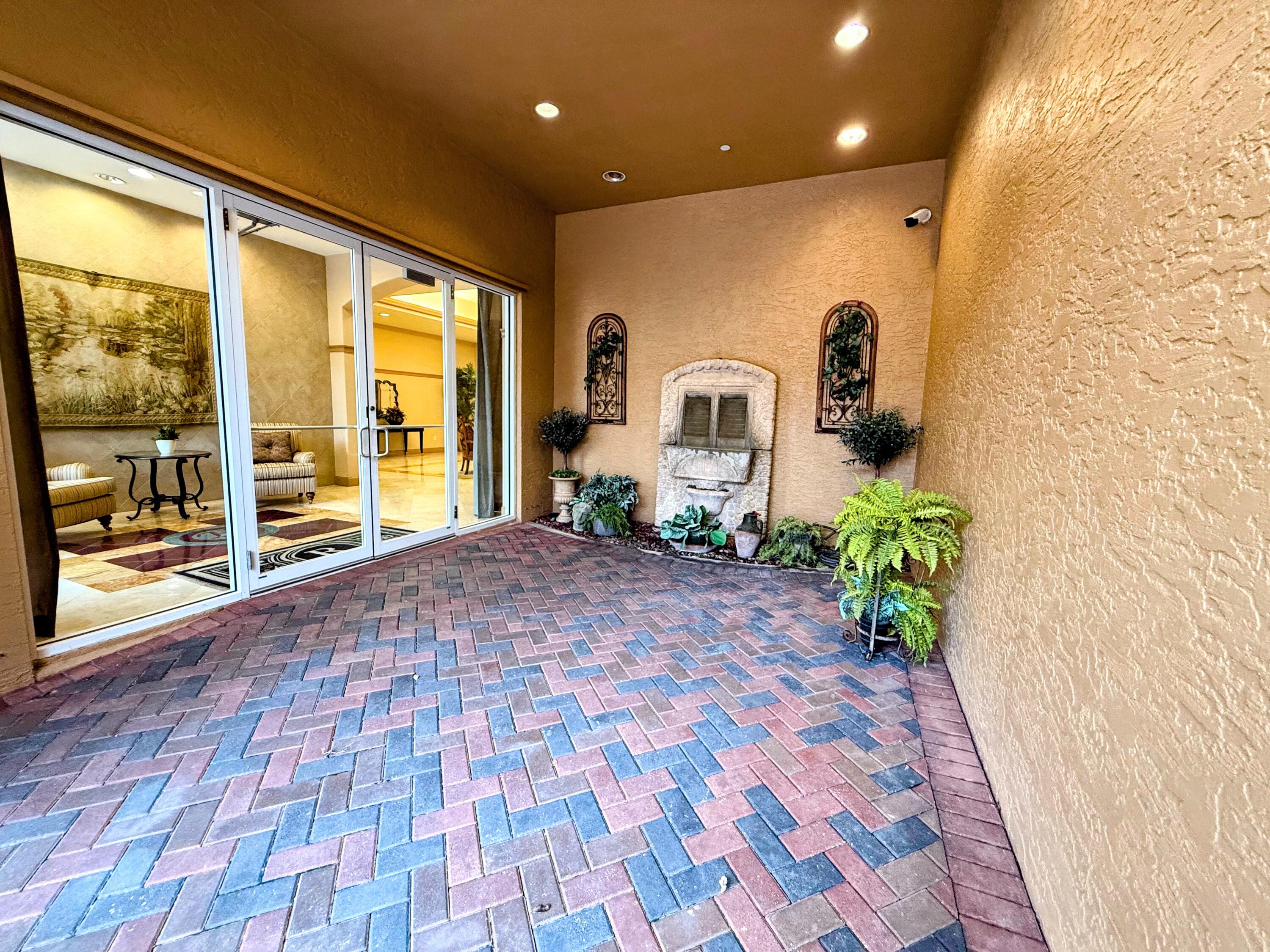 20 Orange Avenue, Unit 9 Fort Pierce, FL 34950 - Photo 7 of 92 a room with painting on the wall and a potted plant