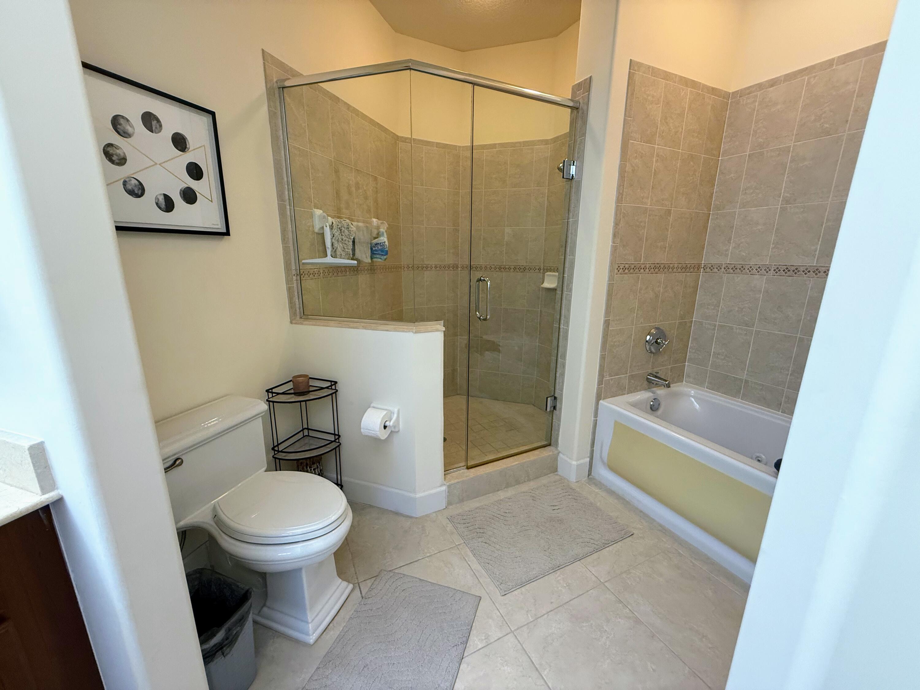 20 Orange Avenue, Unit 9 Fort Pierce, FL 34950 - Photo 78 of 92 a bathroom with a toilet and a shower