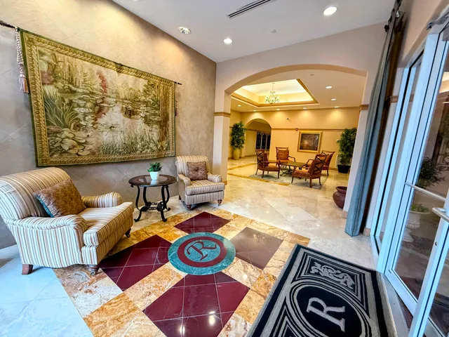 a backyard of a house with barbeque oven table and chairs