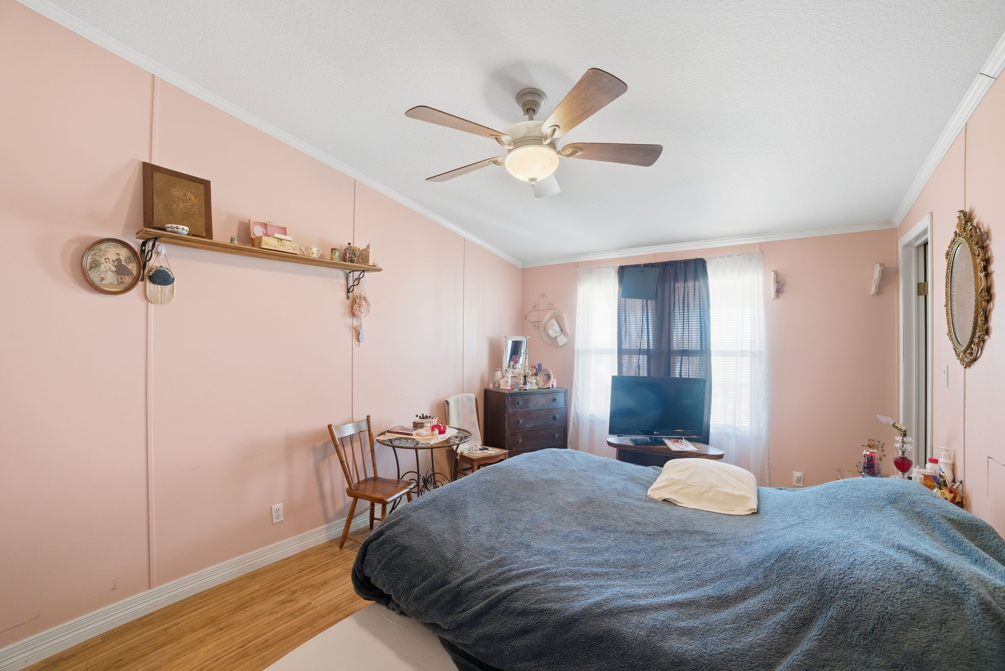 2124 Hackberry Road Salado, TX 76571 - Photo 21 of 27 a bedroom with a bed and a chandelier