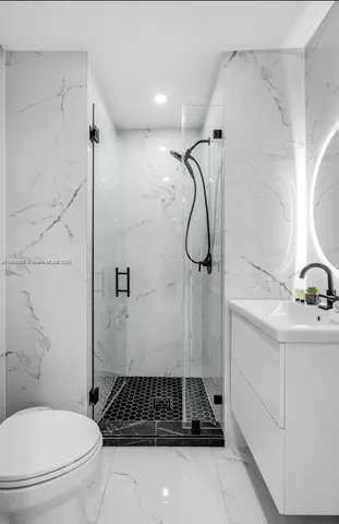 a bathroom with a shower a toilet and a sink