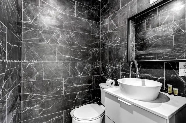 a bathroom with a toilet and a sink