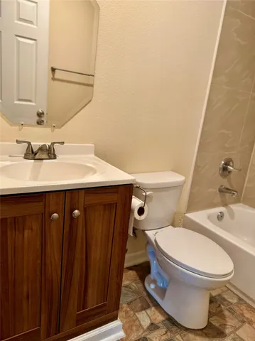 a bathroom with a sink a toilet and mirror