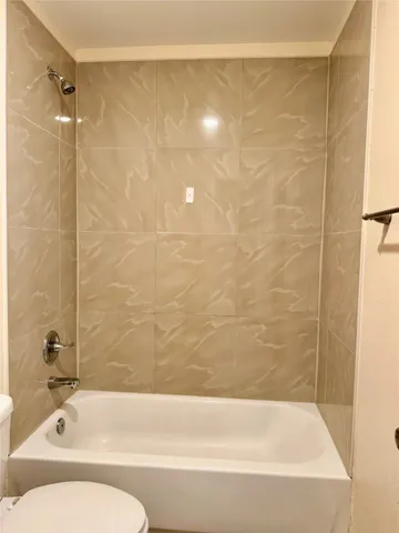 a bathroom with a bathtub and shower