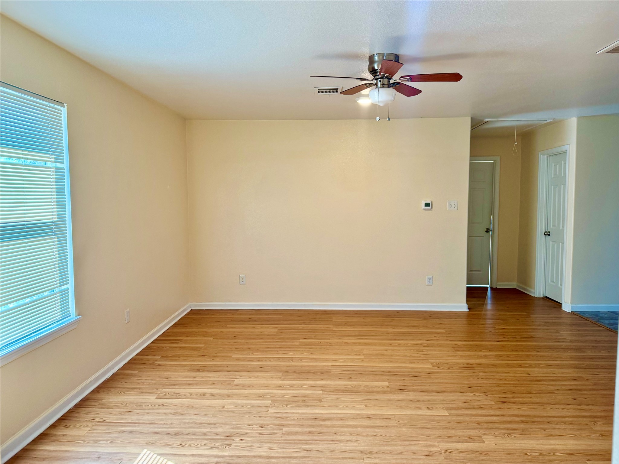 711 Hahlo Street Houston, TX 77020 - Photo 2 of 13 a view of an empty room with window and wooden floor