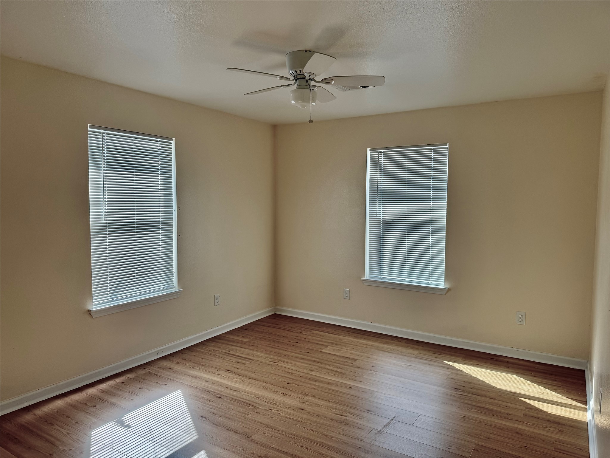 711 Hahlo Street Houston, TX 77020 - Photo 7 of 13 a view of an empty room with wooden floor and a window
