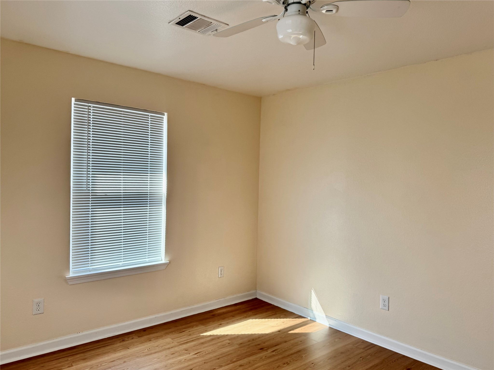 711 Hahlo Street Houston, TX 77020 - Photo 8 of 13 a view of an empty room with a window and wooden floor