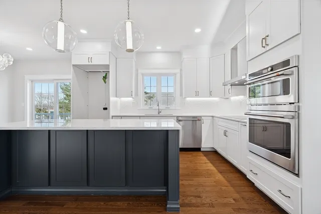 a kitchen with a sink window and cabinets