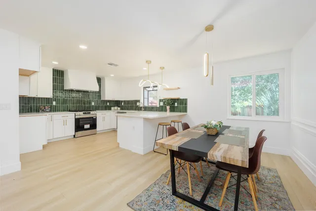 a view of a dining room with furniture and wooden floor
