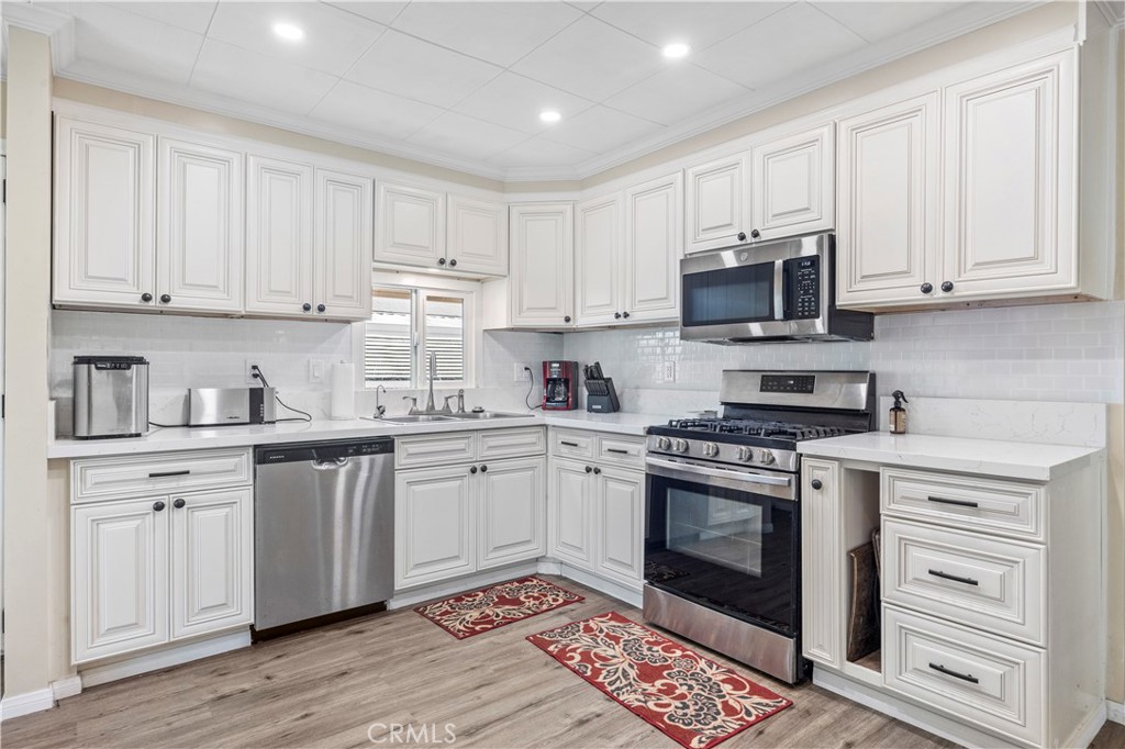 127 Brookside Lane Oceanside, CA 92056 - Photo 11 of 30 a kitchen with granite countertop a sink stainless steel appliances and cabinets