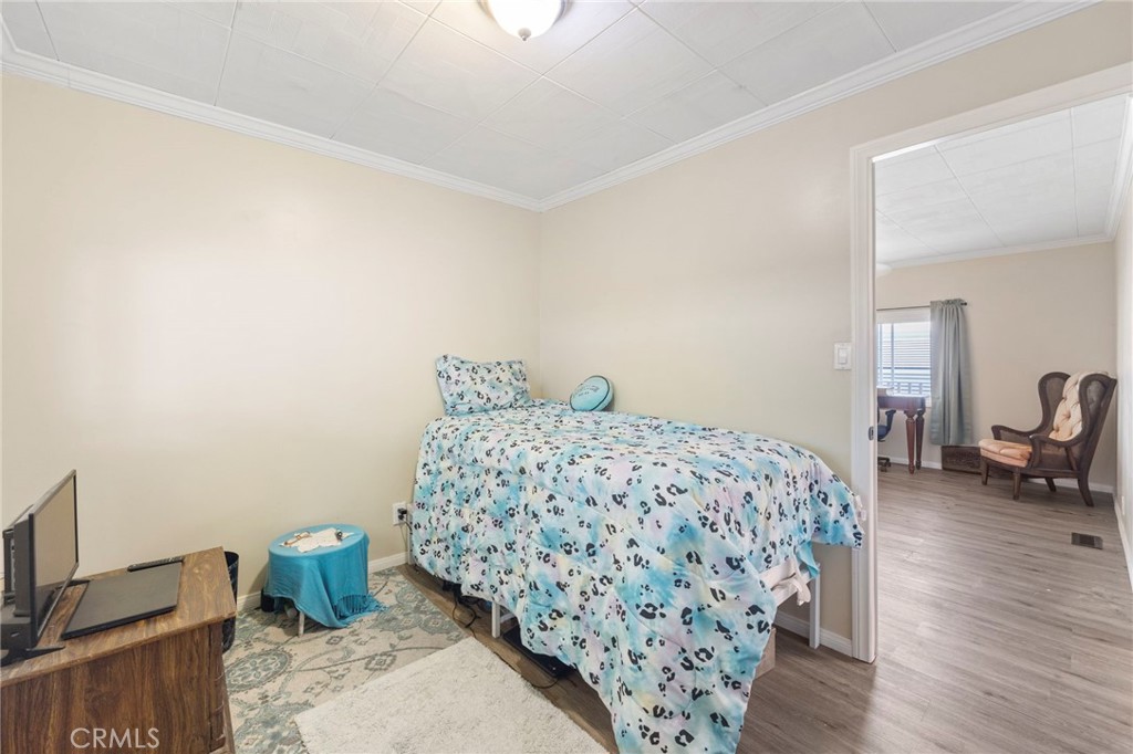 127 Brookside Lane Oceanside, CA 92056 - Photo 18 of 30 a bedroom with a bed and wooden floor