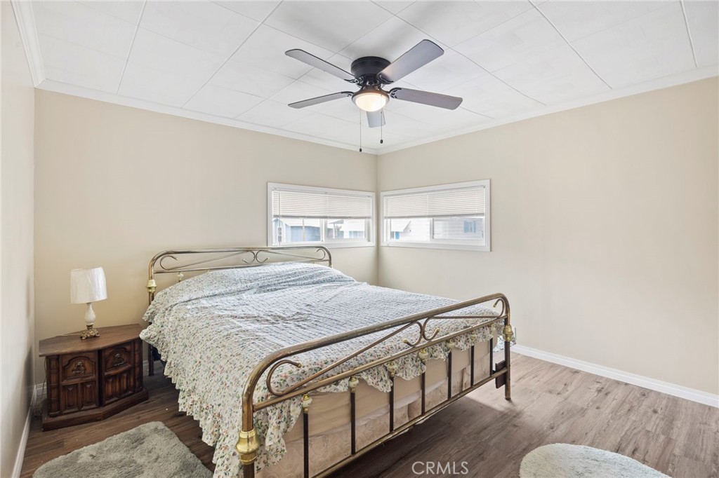 127 Brookside Lane Oceanside, CA 92056 - Photo 20 of 30 a bedroom with a bed and a chandelier