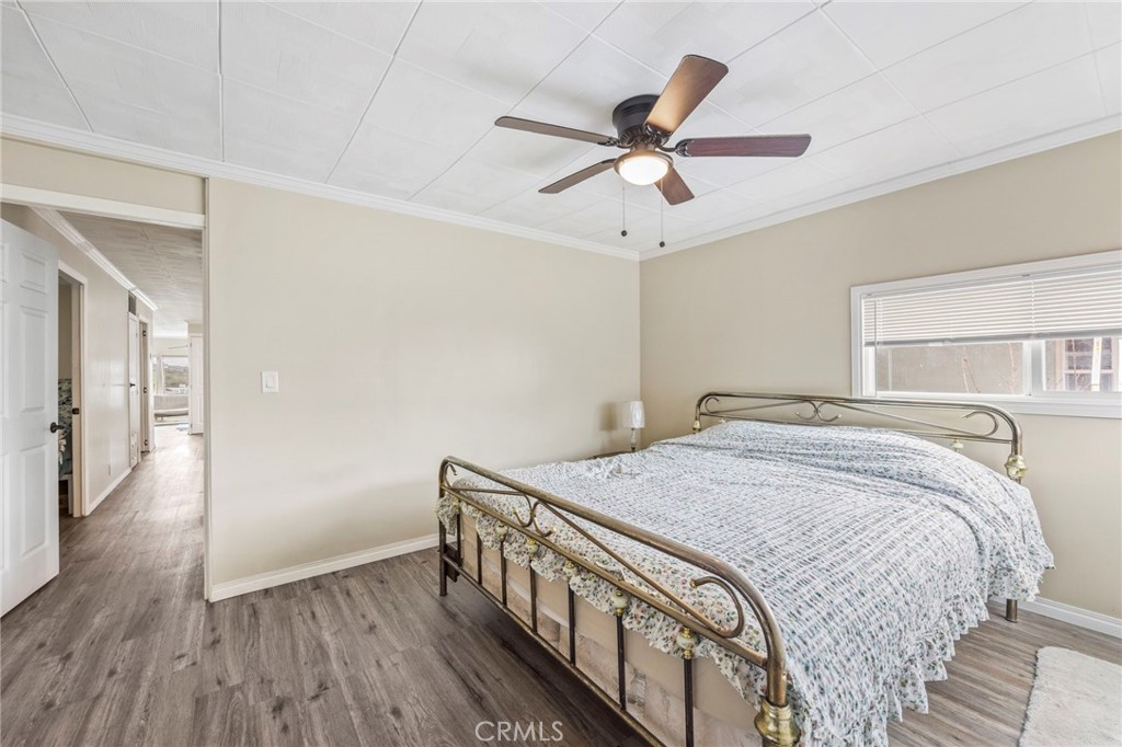 127 Brookside Lane Oceanside, CA 92056 - Photo 22 of 30 a bedroom with a bed and a chandelier