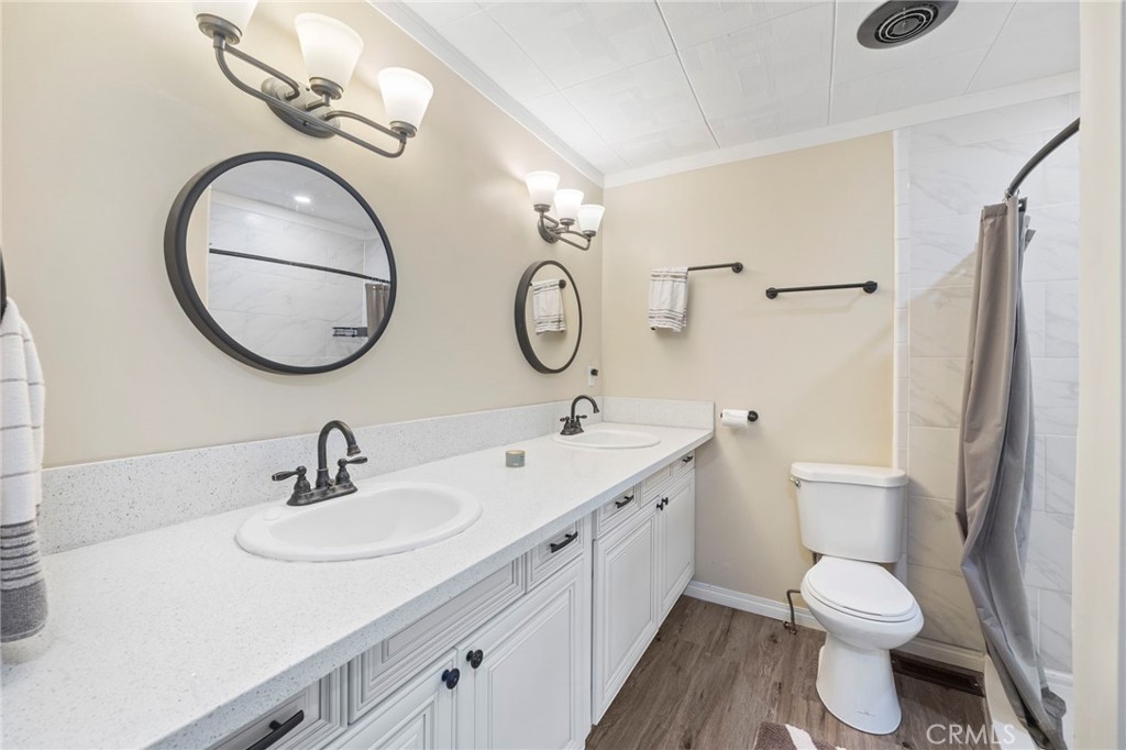 127 Brookside Lane Oceanside, CA 92056 - Photo 23 of 30 a bathroom with a toilet a sink and mirror