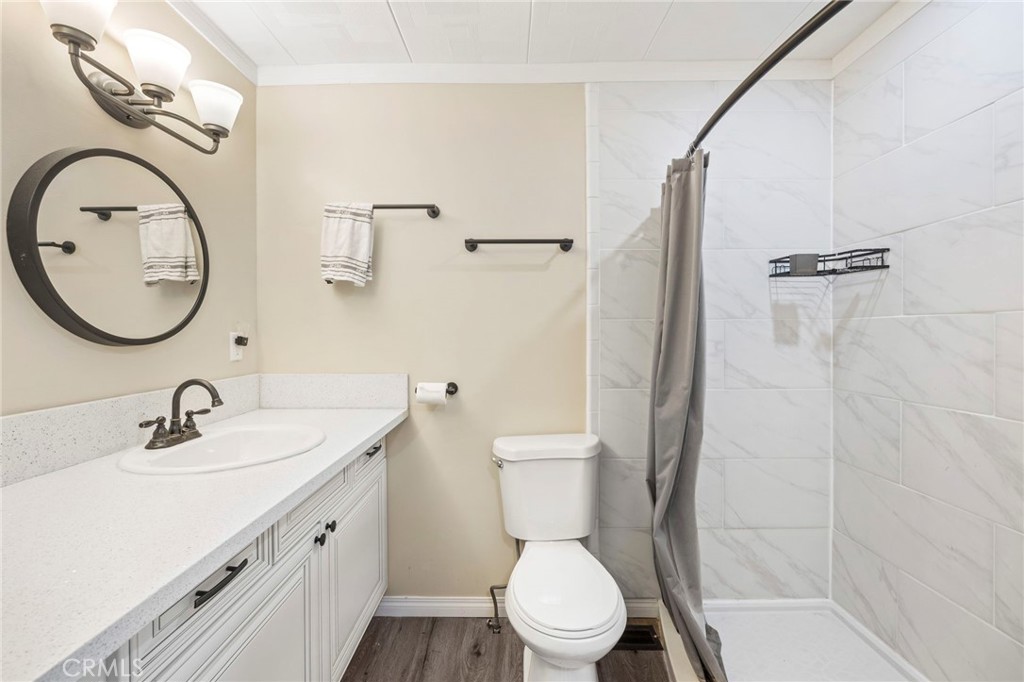 127 Brookside Lane Oceanside, CA 92056 - Photo 24 of 30 a bathroom with a toilet sink vanity and mirror