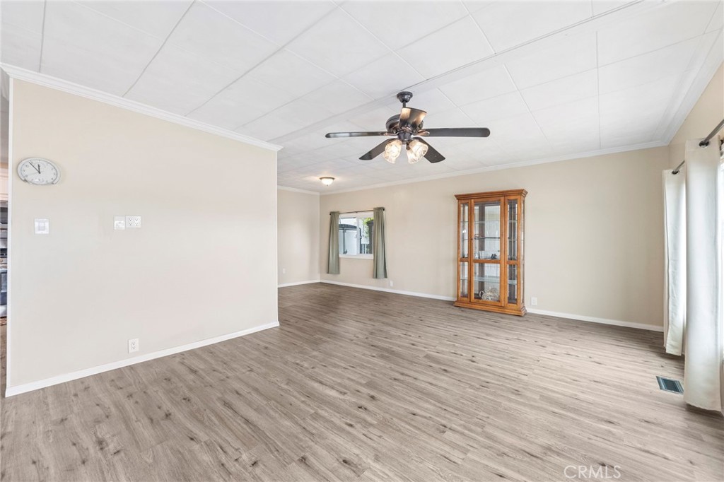 127 Brookside Lane Oceanside, CA 92056 - Photo 7 of 30 a view of an empty room with a window and wooden floor
