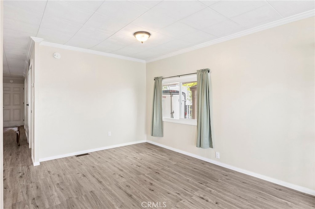 127 Brookside Lane Oceanside, CA 92056 - Photo 8 of 30 a view of an empty room with wooden floor and a window