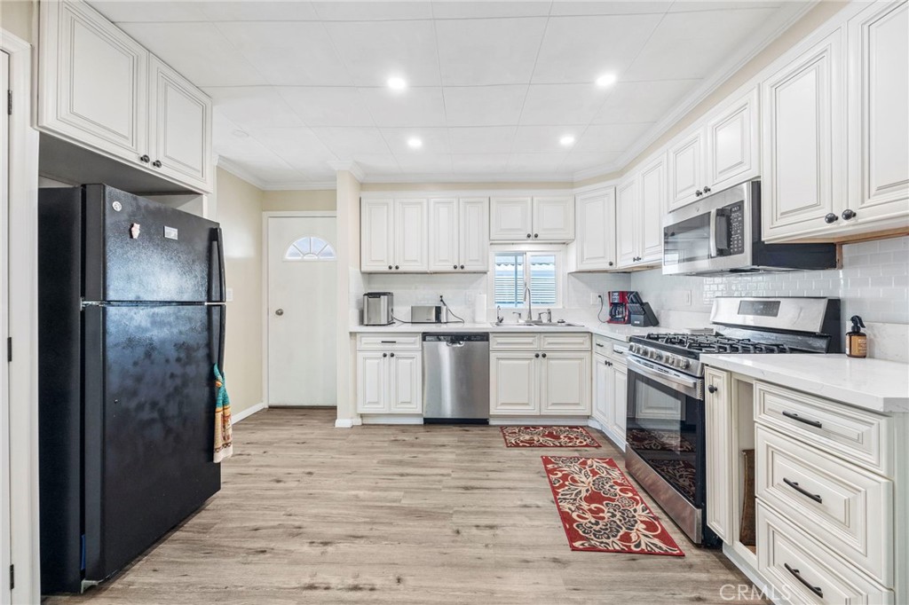 127 Brookside Lane Oceanside, CA 92056 - Photo 9 of 30 a kitchen with stainless steel appliances granite countertop a refrigerator sink and cabinets