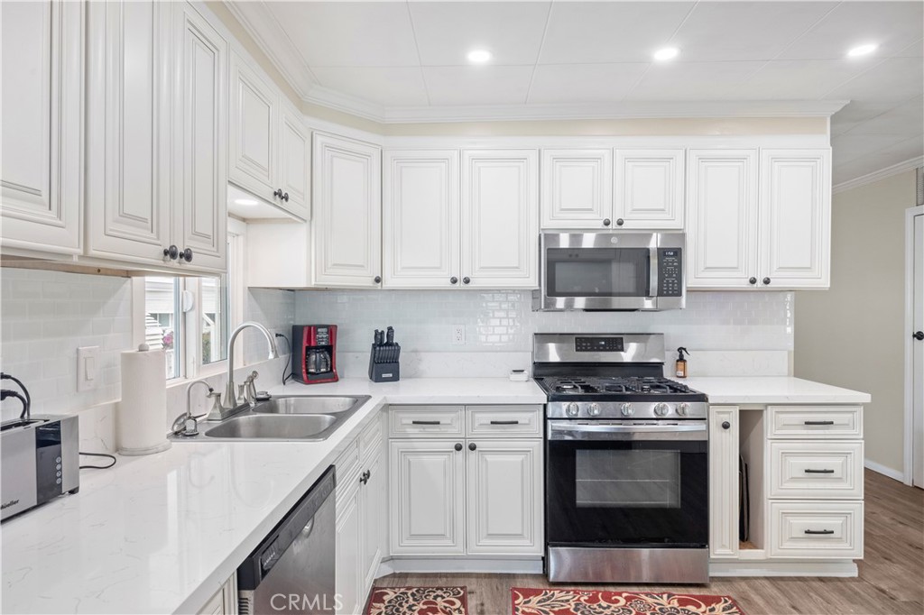 127 Brookside Lane Oceanside, CA 92056 - Photo 10 of 30 a kitchen with stainless steel appliances granite countertop a stove a sink and a microwave