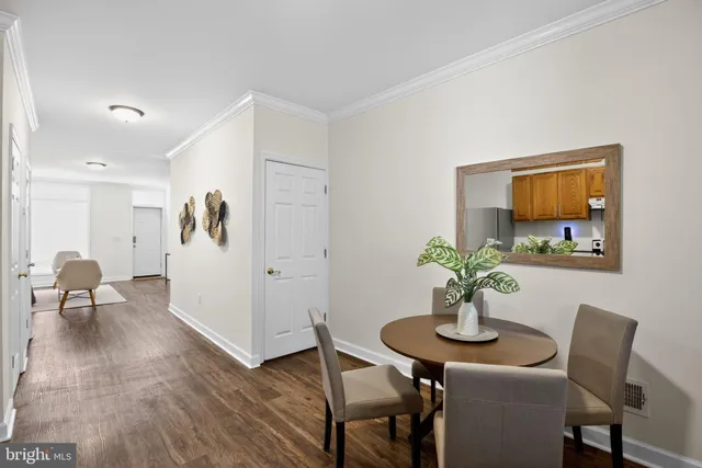 a view of a hallway with wooden floor and stairs