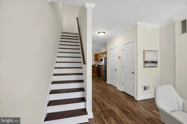 a bathroom with a toilet sink vanity and mirror