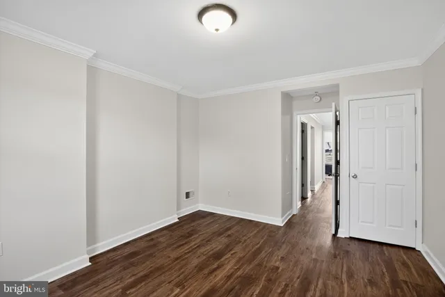 a view of in closet with a white door