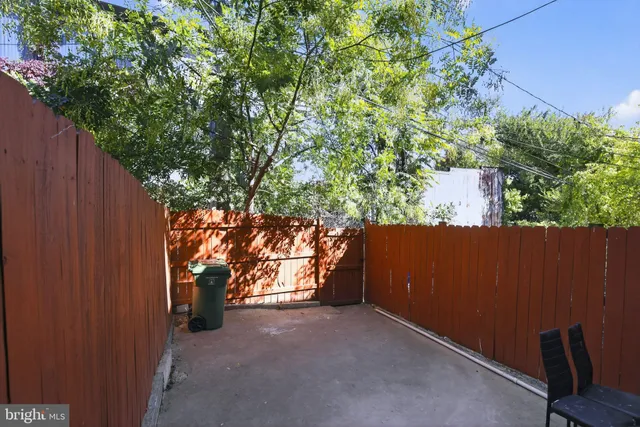a view of house with backyard and sitting area