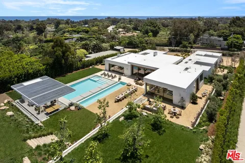 an aerial view of a house with a yard