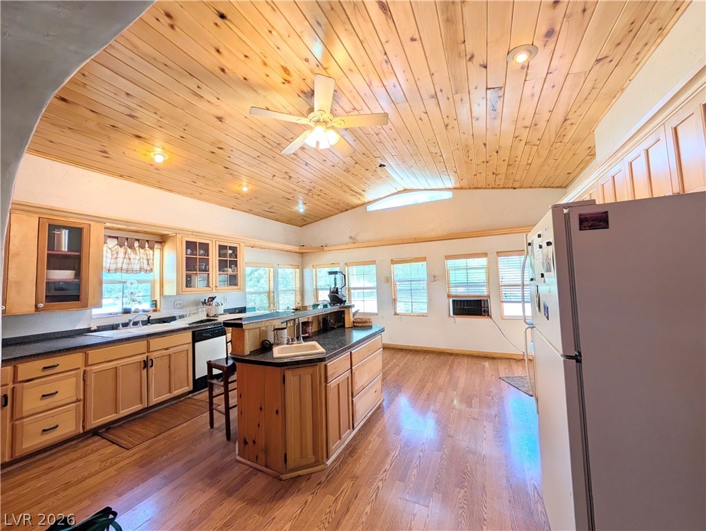 997 Phillips Street Panaca, NV 89042 - Photo 7 of 19 A rustic-inspired kitchen features warm wooden cabinetry, rich hardwood flooring, and abundant natural light.