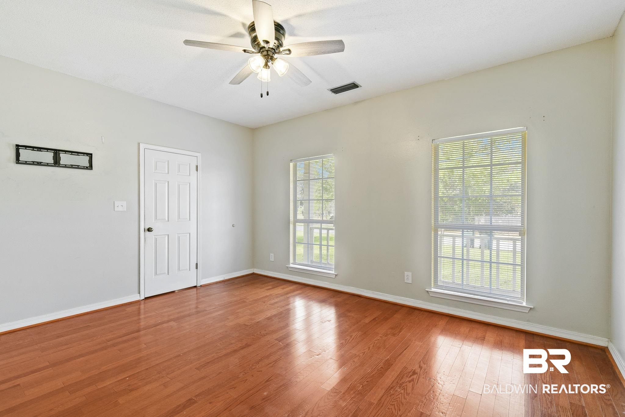 474 Ridgewood Drive Daphne, AL 36526 - Photo 28 of 57 Spare room with ceiling fan, a healthy amount of sunlight, and hardwood / wood-style floors