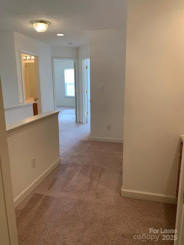 an empty room with windows and entrance