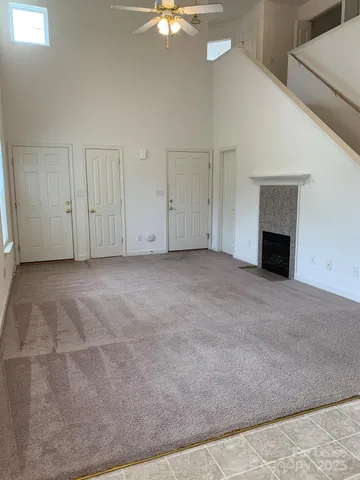 a view of a livingroom with an empty space and a fireplace