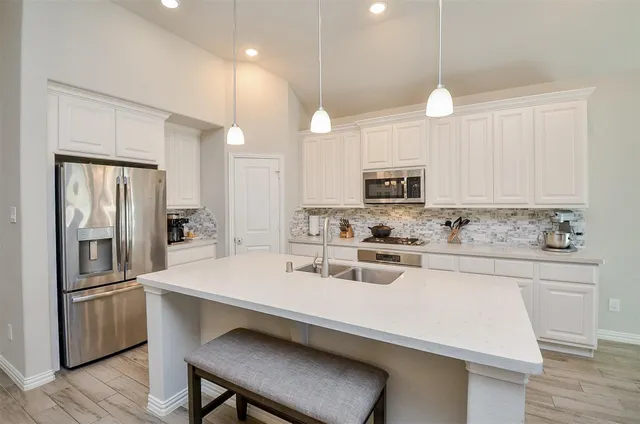 a kitchen with a sink stove and refrigerator