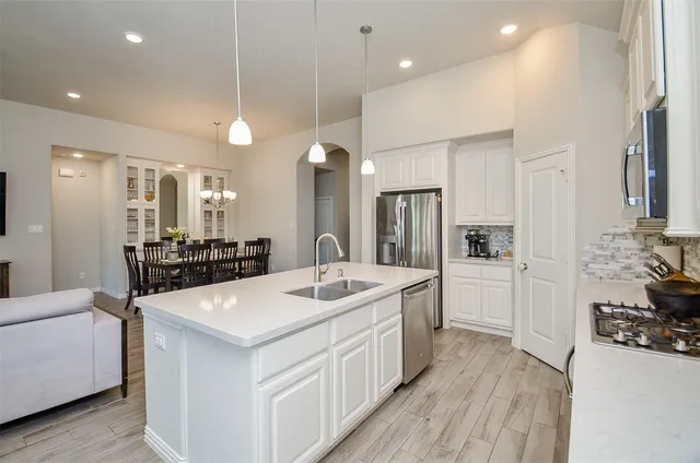 a kitchen with stainless steel appliances a stove a microwave and cabinets