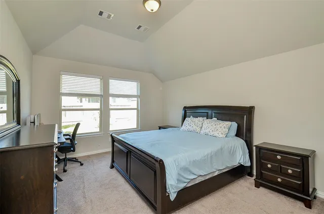 a bedroom with a bed and a dresser