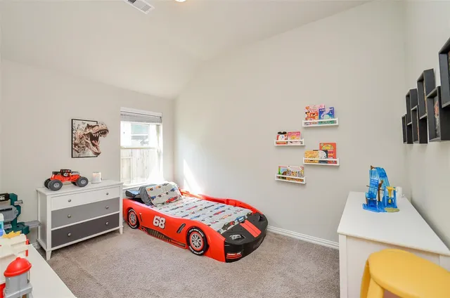 a bedroom with furniture a baby crib and a window