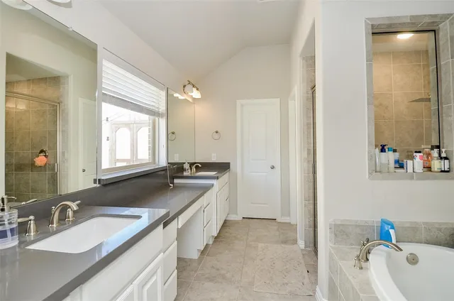 a bathroom with a tub and shower