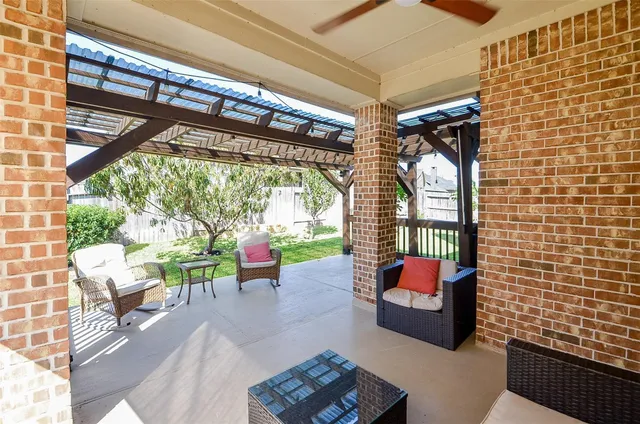 a balcony with furniture and a ceiling fan