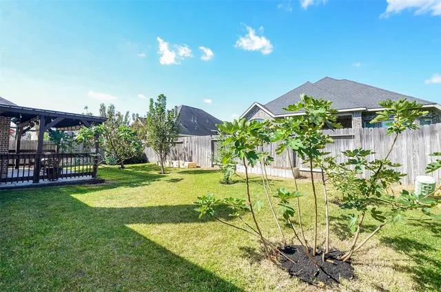 a view of a house with backyard and sitting area