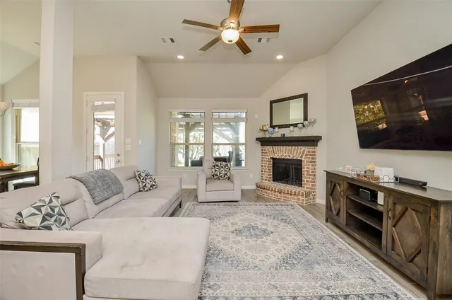 a living room with furniture fireplace and flat screen tv