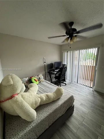 a living room with furniture and a ceiling fan