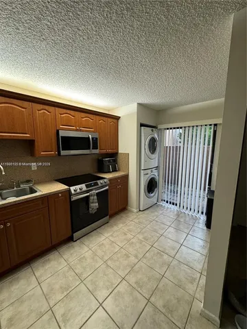 a kitchen with stainless steel appliances granite countertop a stove and a sink