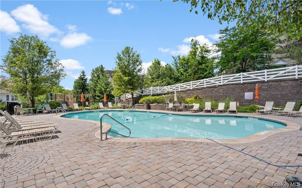 5 Case Court Monroe, NY 10950 - Photo 33 of 35 a view of swimming pool with seating space and trees in the background