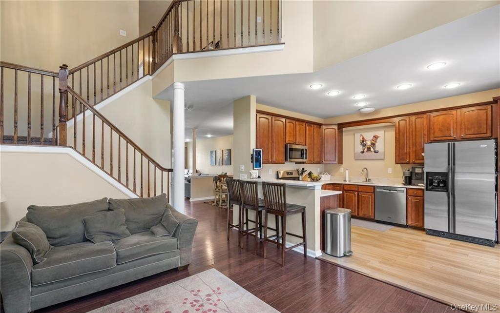 5 Case Court Monroe, NY 10950 - Photo 8 of 35 a living room with stainless steel appliances kitchen island granite countertop a couch a dining table and chairs with wooden floor